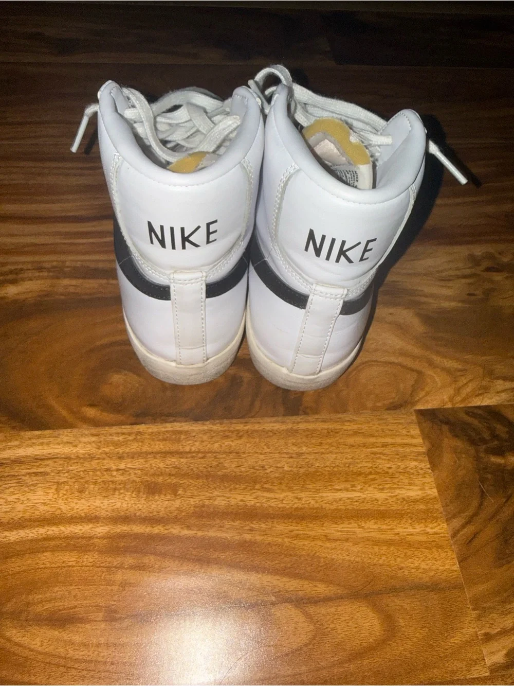 Nike White High-Top Sneakers with Black Swoosh